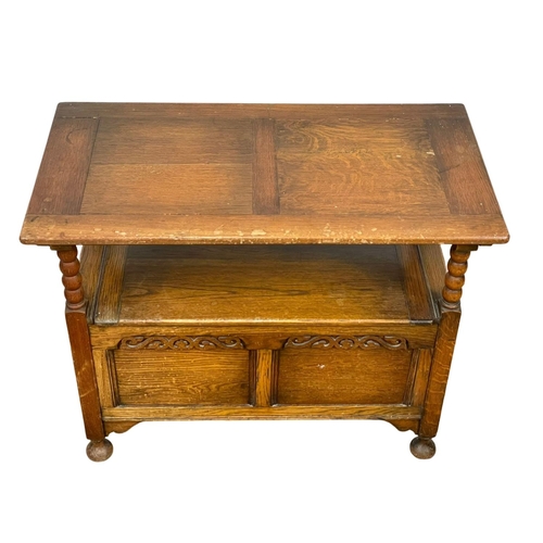 27 - An early 20th century oak hall bench combination table. Bench measures 91 x 45 x 92cm.