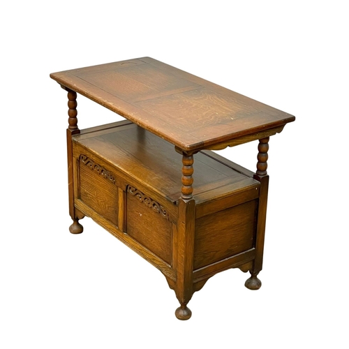 27 - An early 20th century oak hall bench combination table. Bench measures 91 x 45 x 92cm.
