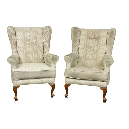 42 - A pair of vintage wingback armchairs. 75 x 79 x 100cm