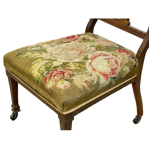43 - An Edwardian nursing chair with tapestry seat.