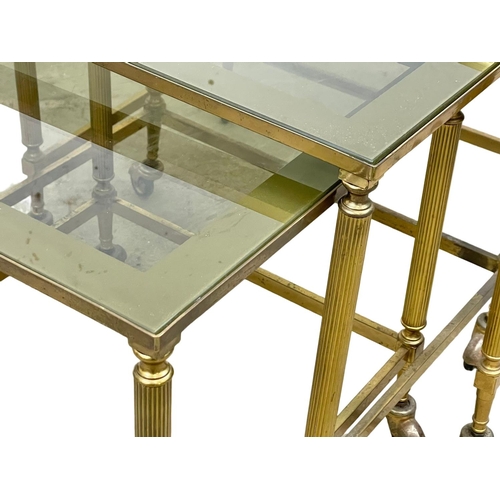 59 - A vintage brass framed nest of tables, with smoked glass top.