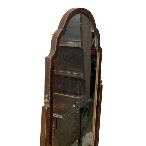 63 - A vintage mahogany cheval mirror. 142cm