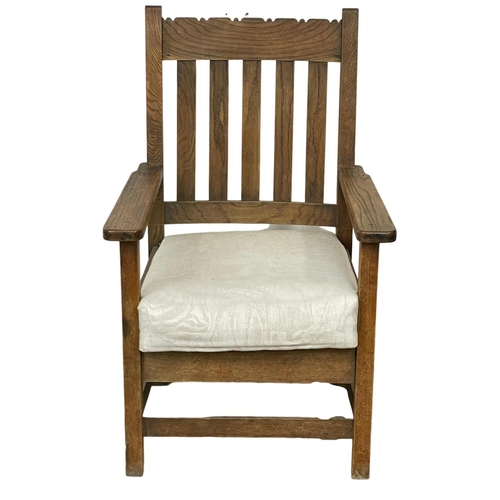 1037 - An early 20th century heavy oak armchair. Circa 1900 x 1920. 68.5 x 56.5 x 106.5cm