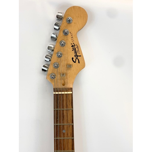 196S - An electric guitar by Fender. Squier Strat. 99cm