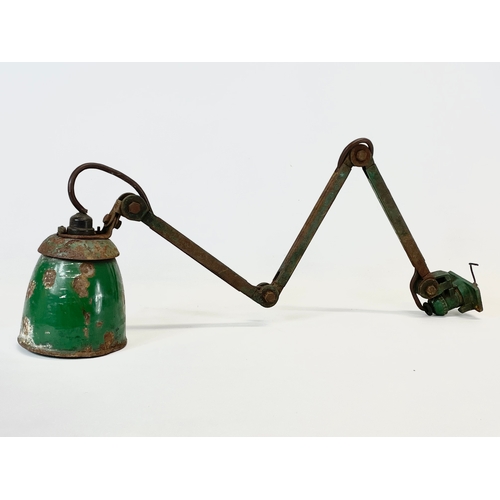 12 - A 1930’s machinists angle poise wall lamp. 65cm not fully extended.