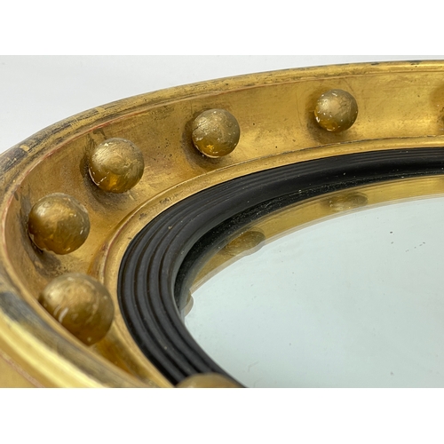 20 - A vintage Regency style gilt framed convex mirror. 45cm