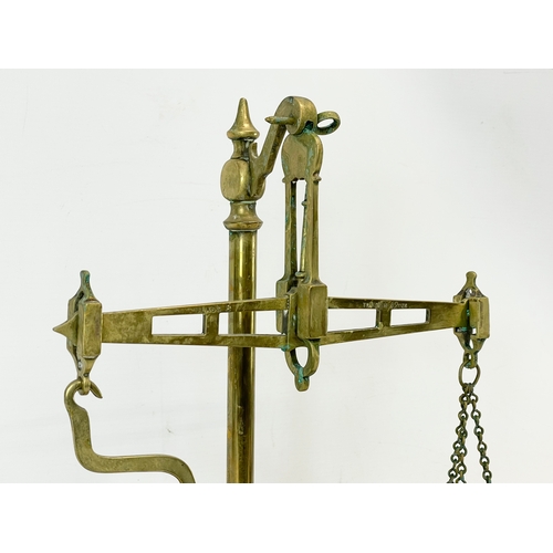 33 - A set of Edwardian oak and brass balance scales. 36x18x44cm