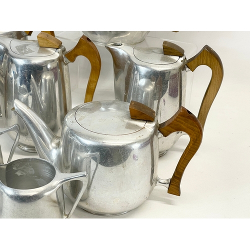 401 - 11 pieces of Mid Century Picquot Ware. 3 teapots, 5 coffee pots, 3 milk jugs and a sugar bowl.