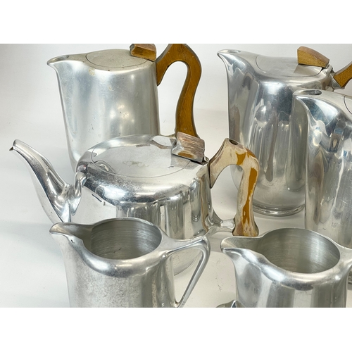 401 - 11 pieces of Mid Century Picquot Ware. 3 teapots, 5 coffee pots, 3 milk jugs and a sugar bowl.