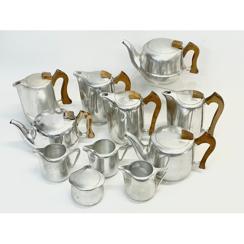 401 - 11 pieces of Mid Century Picquot Ware. 3 teapots, 5 coffee pots, 3 milk jugs and a sugar bowl.