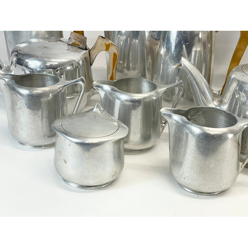 401 - 11 pieces of Mid Century Picquot Ware. 3 teapots, 5 coffee pots, 3 milk jugs and a sugar bowl.