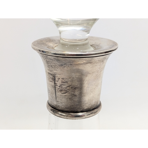 402 - A silver top crystal decanter.