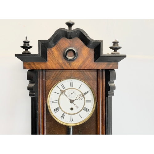 52 - A large Victorian Walnut Vienna wall clock, with 1 weight, pendulum and key. 117cm