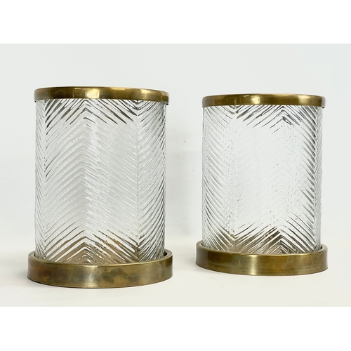 73 - A pair of large glass and brass Hurricane candleholders, by Eichholtz Paloma. 22x29cm