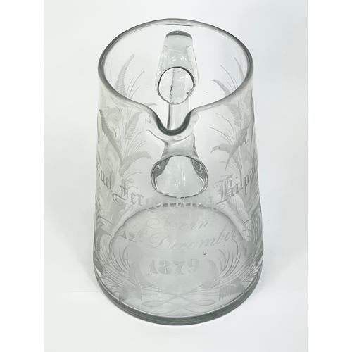 418 - A Victorian glass jug. Engraved. 12x13.5cm