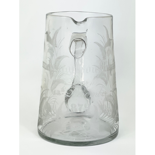 418 - A Victorian glass jug. Engraved. 12x13.5cm