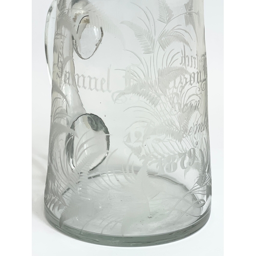 418 - A Victorian glass jug. Engraved. 12x13.5cm