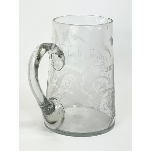 418 - A Victorian glass jug. Engraved. 12x13.5cm