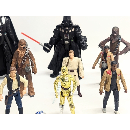 149 - A collection of Star Wars figures, including Hans Solo, Darth Vader, Chewbacca, R2-D2, C-3PO, Obi wa... 