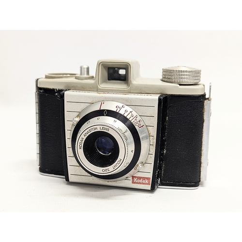 152 - A vintage Zenit-B 35mm camera, made in USSR in original case with strap. With a 1955 Kodak 'Bantam' ... 