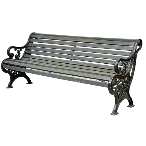 913 - A large early 20th century cast iron garden bench with wooden straps. Circa 1900-1920. 186x73x83cm