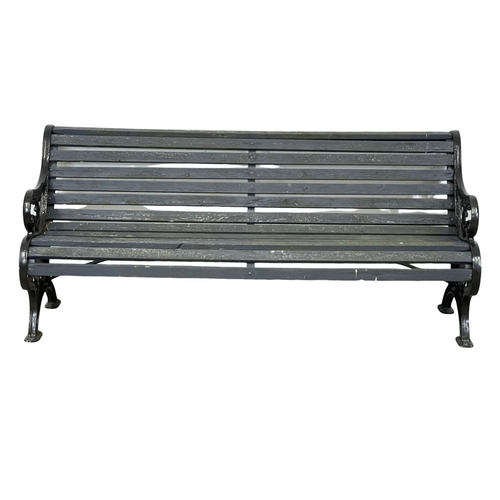 913 - A large early 20th century cast iron garden bench with wooden straps. Circa 1900-1920. 186x73x83cm