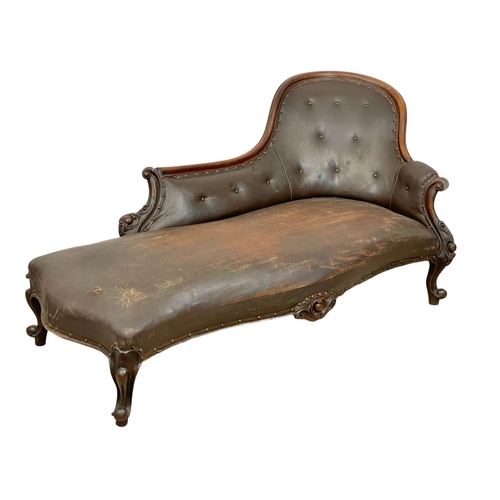 922 - A Victorian carved mahogany chaise lounge with early 20th century leather. 178cm