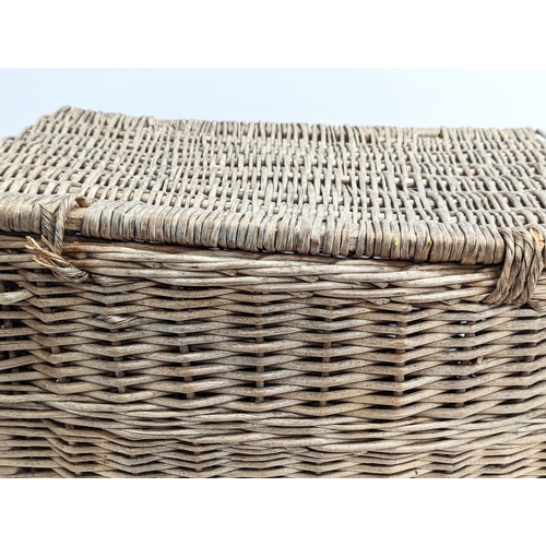 377 - A vintage heavy wicker basket. 59.5x40x36.5cm