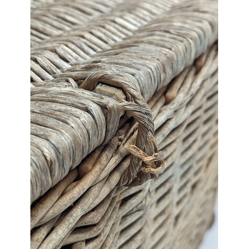 377 - A vintage heavy wicker basket. 59.5x40x36.5cm