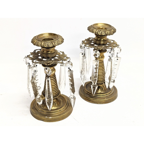 122 - A pair of Victorian brass candlesticks with glass droplets. 16.5xcm