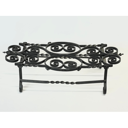 204 - A wrought iron pot stand. 61x29x15cm