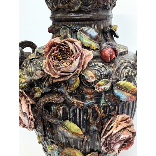 424 - A large late 19th century Barbotine Majolica pottery vase with roses and rams head decorations. 72.5... 