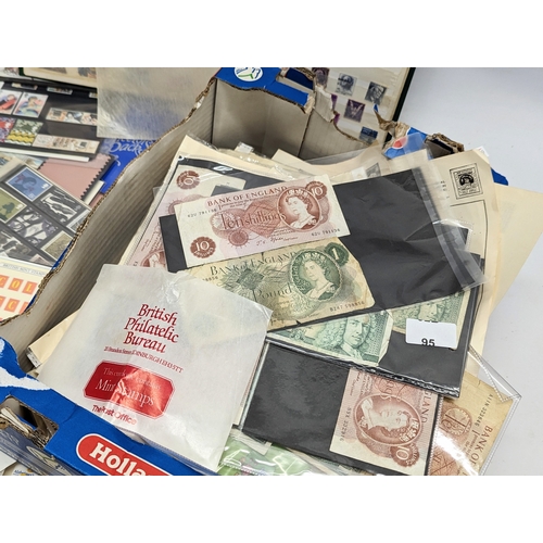 586 - A large quantity of vintage stamps, badges, stamp albums, bank notes