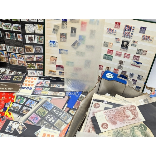 586 - A large quantity of vintage stamps, badges, stamp albums, bank notes