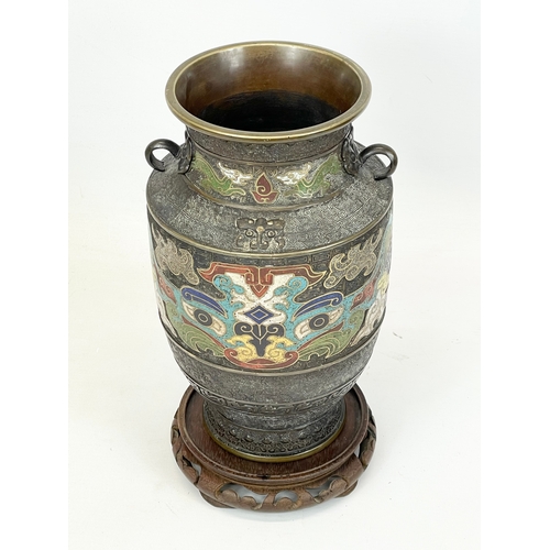 222 - A 19th century Chinese bronze and cloisonné vase, with wooden base. 26cm