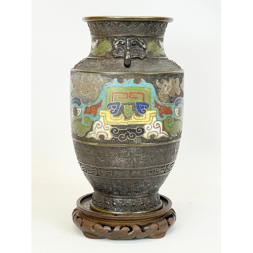 222 - A 19th century Chinese bronze and cloisonné vase, with wooden base. 26cm