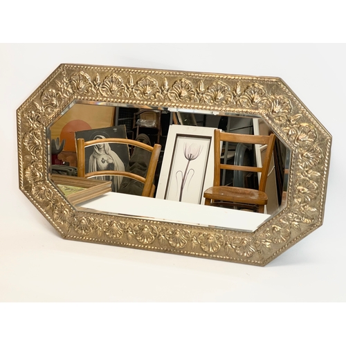 236 - A vintage brass framed mirror. 74x43.5cm