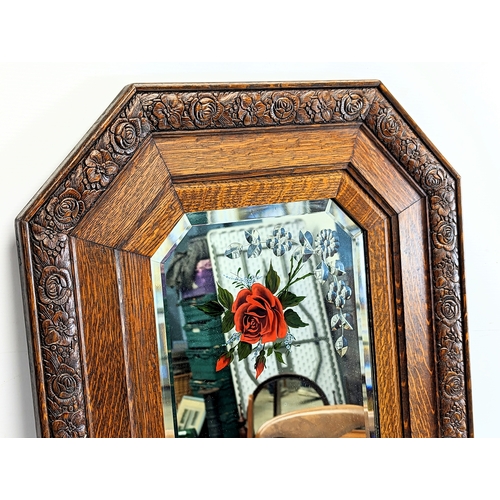 239 - A 1930s oak framed bevelled mirror. 52.5x83cm