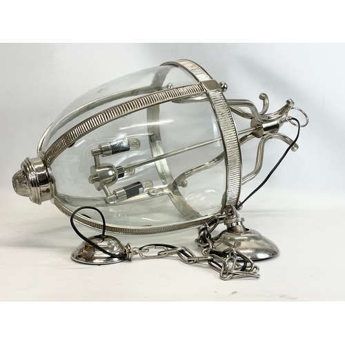 241 - A large polished chrome light fitting with glass panels. 73cm without chain. 145cm with chain.