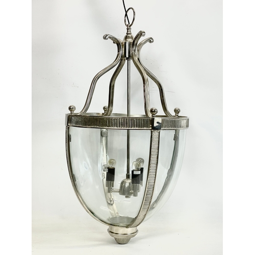 241 - A large polished chrome light fitting with glass panels. 73cm without chain. 145cm with chain.