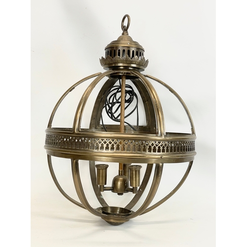 242 - A large brass light fitting. 46x65cm