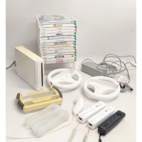 172 - An Nintendo Wii game console with 3 remotes, 2 Nintendo Wii wheel, accessories and games including W... 