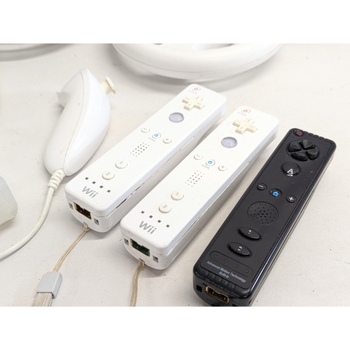 172 - An Nintendo Wii game console with 3 remotes, 2 Nintendo Wii wheel, accessories and games including W... 