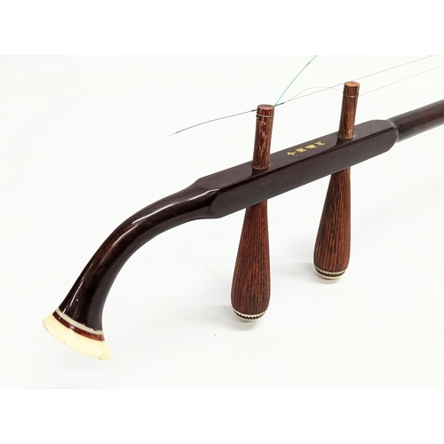 245 - A rosewood and snakeskin Chinese Erhu musical instrument in case.