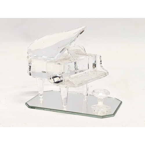 435 - A Swarovski Crystal grand piano and stool in original box. 6cm