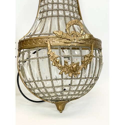 249 - A pair of large French Empire style ornate brass basket wall lights with crystal droplets. 32x71cm