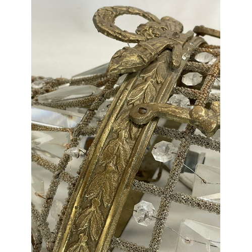 249 - A pair of large French Empire style ornate brass basket wall lights with crystal droplets. 32x71cm