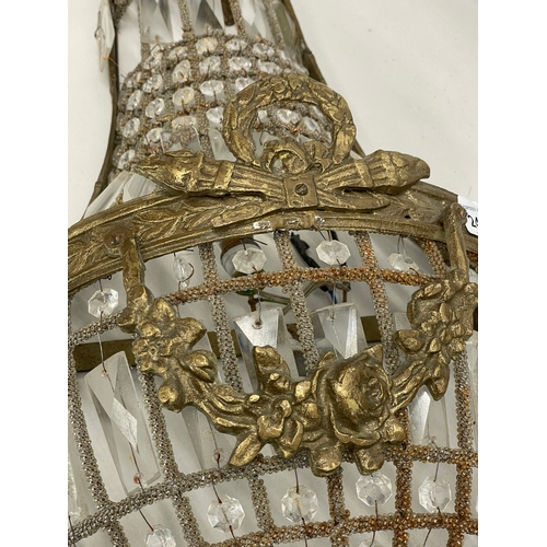 249 - A pair of large French Empire style ornate brass basket wall lights with crystal droplets. 32x71cm