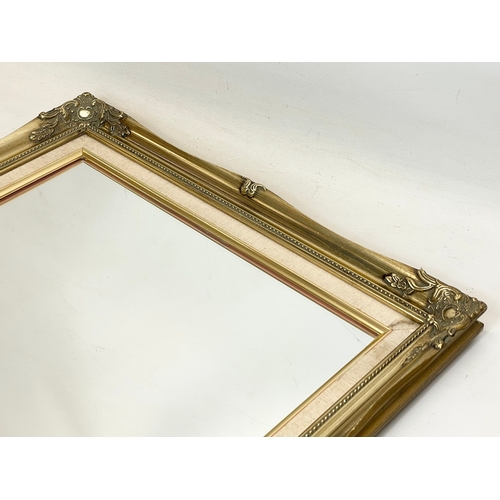 250 - A pair of ornate gilt framed mirrors. 42x52cm