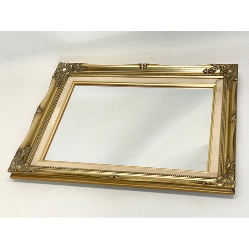 250 - A pair of ornate gilt framed mirrors. 42x52cm